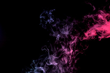 Dense multicolored smoke of purple and pink on a black isolated background. Background of smoke vape