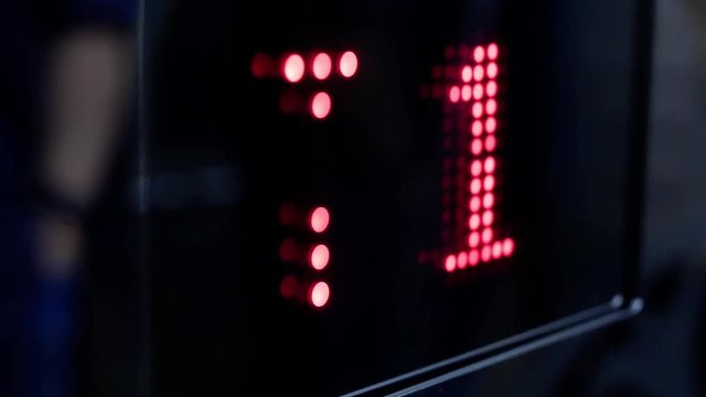 Motion of people taking elevator from three to one floor with reflection shadow of blur people inside shopping mall with 4k resolution.