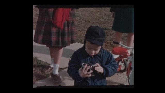 1955 Little boy with vintage antique camera
