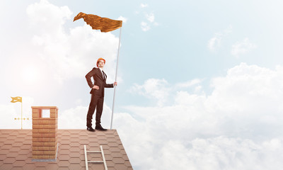 Young businessman with flag presenting concept of leadership. Mixed media