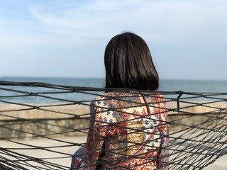 woman sitting at sea beach