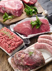 Photo sur Plexiglas Viande Different types of fresh raw meat on dark wooden background.