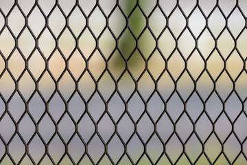 Fototapeta premium Closeup of Seamless black metal texture grid with nature background. Copy space