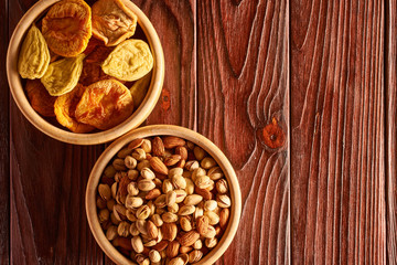 Dried fruits and nuts on wooden background