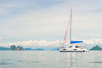 Naklejka premium horizontal toned photo - white yacht in the bay of the Andaman Sea, Thailand