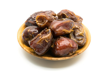 Dried dates fruit in wooden plate