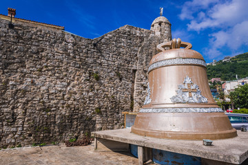 Bell next to Old Town walls in Budva, Montenegro