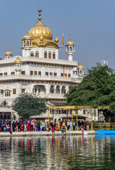 Akal Takht, Sikh Political Assembly building, Amritsar, India. .Reflections of white buildings of the Sikh religious authority on the water of the sacred pond.