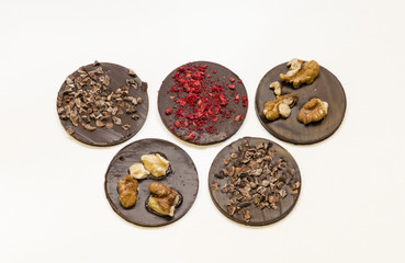 Chocolate medals with different crumbs. Sweet present