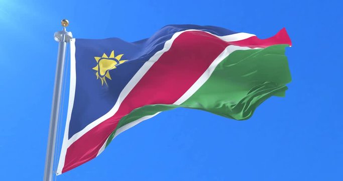 Flag of Namibia waving at wind in slow in blue sky, loop