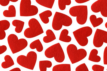Red felt hearts of different sizes isolated on white background. Valentines day pattern.