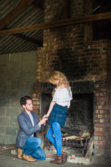 Fototapeta premium The young romantic handsome man doing proposal his young beautiful woman near the brick oven