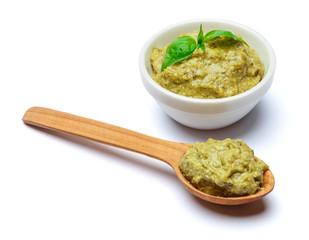 Pesto Sauce with Basil and wooden spoon on White Background Studio shot