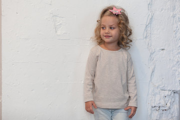 A nice little girl in a gray blank sweatshirt. Mock up.