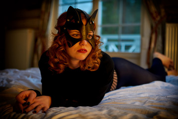 Seductive playful cat-woman in sexy costume