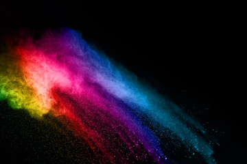 abstract colored dust explosion on a black background.abstract powder splatted background,Freeze motion of color powder exploding/throwing color powder, multicolored glitter texture.