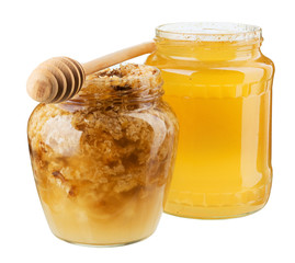 Two jars with honey and honeycomb