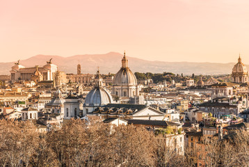 Fototapeta na wymiar Rooftops view of Rome historical architecture and city skyline at sunset, Italy.
