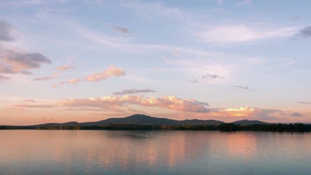 timelapse, the evening to the twilight over the reservoir, floating clouds reflecting with beautiful water.