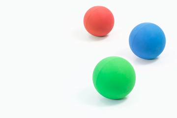 Pet supplies about rubber balls of red, green and blue for pet on isolated white.