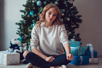 Beautiful blonde girl in gray sweatshirt. Mock-up.