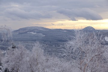 The view from Jedlova hora in Czech Republic. Landscape of Bohemian Switzerland National park in winter.