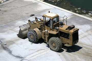 A bulldozer in making a concrete pier in mykonos, Greece