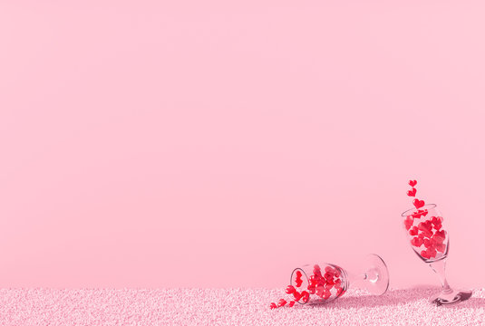 Many red hearts in glass wine on pink carpet in pink room and pink wall.  Rooms of Love on Valentine`s Day. Background and interior. 3D render.