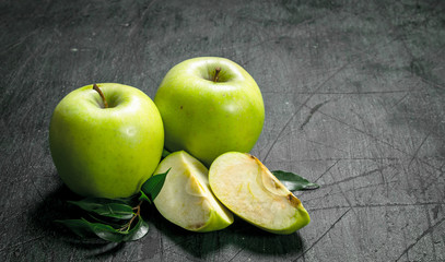 Green apples with leaves.