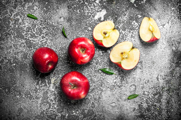Fresh red apples. On rustic background.