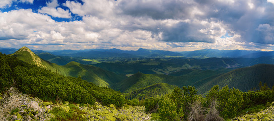 Fototapeta na wymiar Carpathian mountains summer landscape with dramatic clouds and mossy stones. Panoramic view