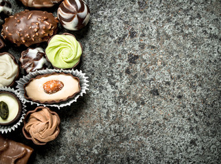 Chocolate candies. On rustic background.