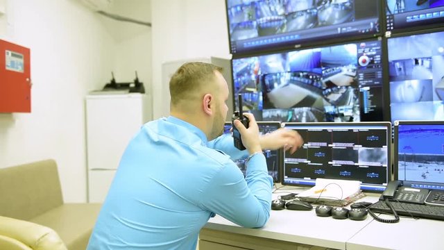 Security worker during monitoring. Video surveillance system.