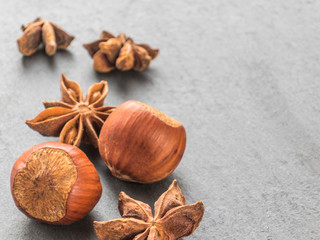 Nuts hazelnuts and anise seeds on a black background. Aniseed