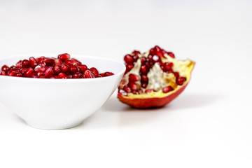 Pomegranate seeds close up on white background