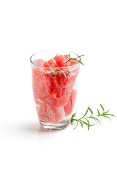 Lemonade with grapefruit and rosemary close-up on a white background.