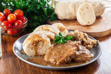 Pork loin in gravy with bread dumplings and sauerkraut