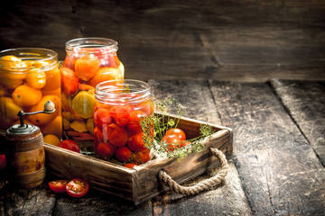 Marinated tomatoes with spices in an old tray.
