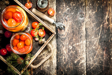 Marinated tomatoes with spices in an old tray.