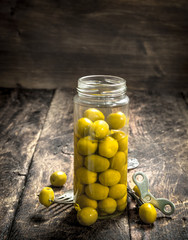 Pickled olives in glass jar.