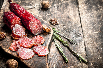 salami with herbs and spices on a board.