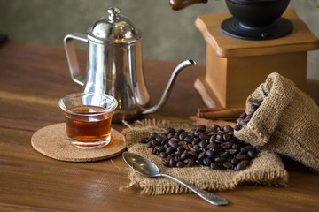 Vintage manual coffee grinder with coffee beans and cup