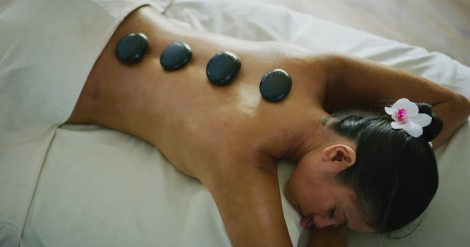 Woman relaxing enjoying hot stone massage at the spa