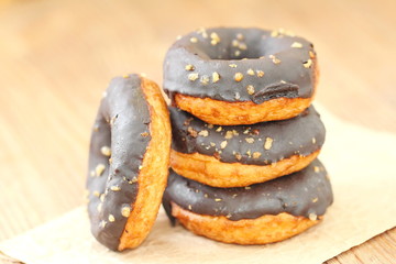 Chocolate doughnuts with chocolate glaze pouring over