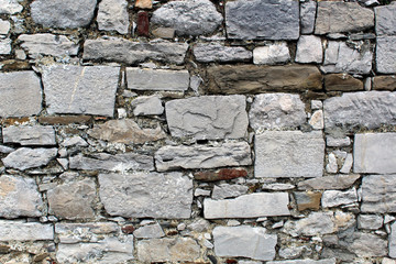 Wall made of rows of rectangular natural stones blocks
