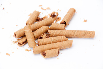 rolled wafer filled with chocolate fudge on white background,