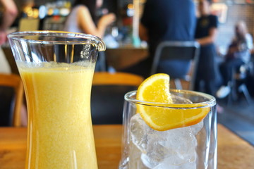Fresh orange juice and glass of ice.