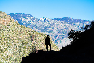 Hiker in Silhouette with Mountains and Sky - 187117777