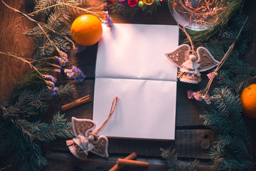 New Year's background. Notepad on wooden boards with decorations.