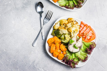 Steamed fish, oil free roasted vegetables. Top view, copy space. 